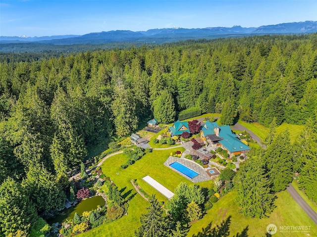 26970 SE Old Black Nugget Rd, Issaquah, WA 98029 - bird's eye view of a forest, a mountainous background, and a pool area