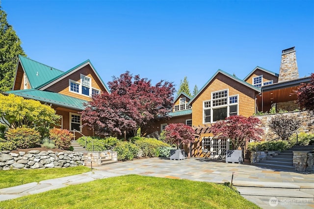 26970 SE Old Black Nugget Rd, Issaquah, WA 98029 - view of front of home featuring a patio, stairway, a standing seam roof, a front yard, and metal roof