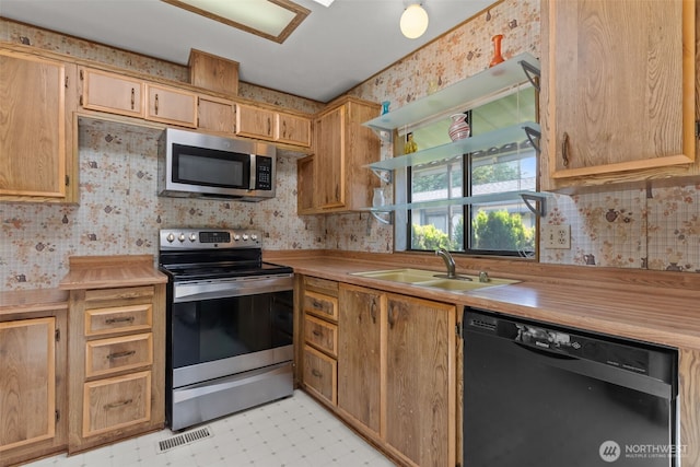 11436SE 208th St Unit 180, Kent, WA 98031 - kitchen with stainless steel appliances, wallpapered walls, light flooring, light countertops, and a sink