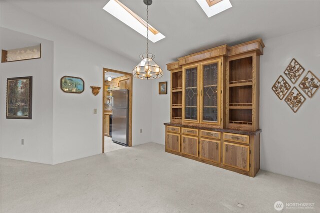 11436SE 208th St Unit 180, Kent, WA 98031 - unfurnished dining area with a skylight, carpet flooring, vaulted ceiling, and a chandelier