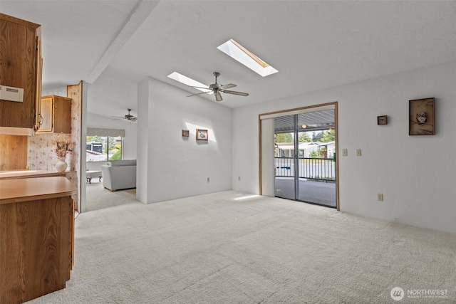 11436SE 208th St Unit 180, Kent, WA 98031 - unfurnished living room featuring a ceiling fan, light carpet, healthy amount of natural light, and vaulted ceiling