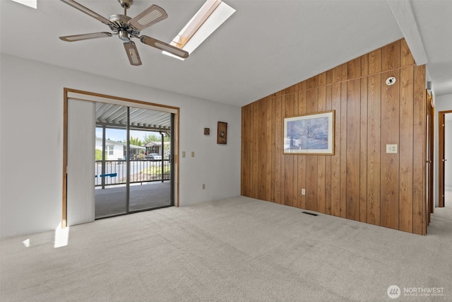 11436SE 208th St Unit 180, Kent, WA 98031 - carpeted spare room with wooden walls, a skylight, ceiling fan, and lofted ceiling