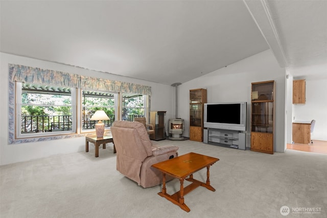 11436SE 208th St Unit 188, Kent, WA 98031 - living room featuring a wood stove, light colored carpet, and vaulted ceiling