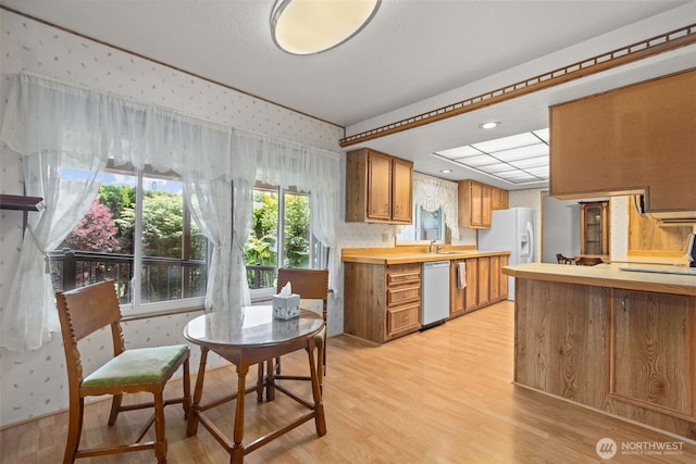 11436SE 208th St Unit 188, Kent, WA 98031 - kitchen with wallpapered walls, dishwasher, white refrigerator with ice dispenser, light wood-style floors, and light countertops