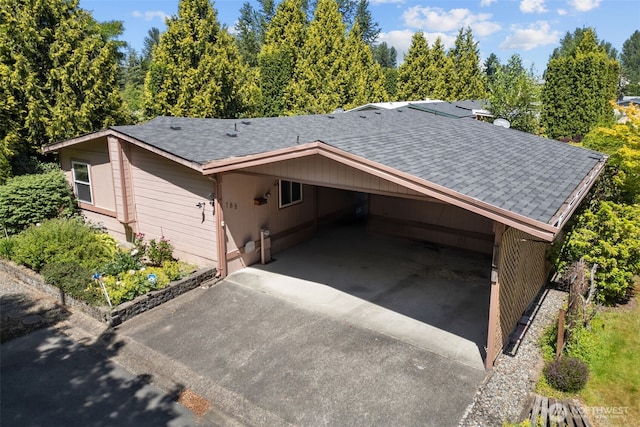 11436SE 208th St Unit 188, Kent, WA 98031 - view of side of property featuring roof with shingles, concrete driveway, and a carport