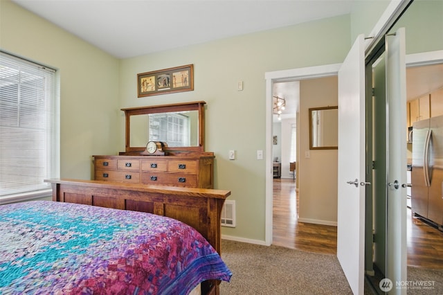 10800 SE 17th Cir Unit T220, Vancouver, WA 98664 - bedroom featuring freestanding refrigerator, carpet flooring, and baseboards
