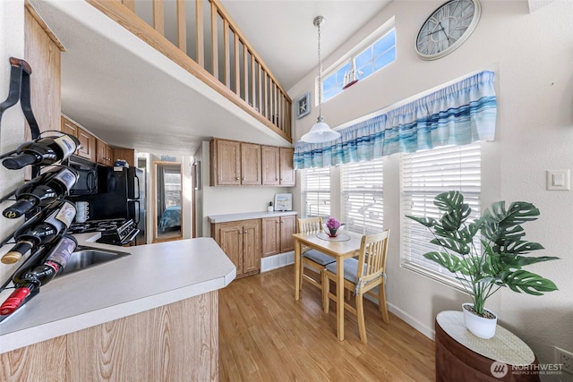 7704 Birch Bay Dr Unit 2805, Blaine, WA 98230 - kitchen featuring a towering ceiling, healthy amount of natural light, light wood finished floors, and light countertops