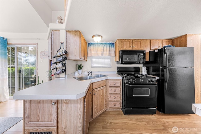 7704 Birch Bay Dr Unit 2805, Blaine, WA 98230 - kitchen featuring black appliances, a sink, light countertops, a peninsula, and light wood-style floors