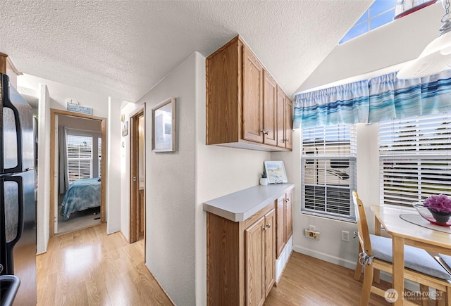 7704 Birch Bay Dr Unit 2805, Blaine, WA 98230 - corridor with light wood-style flooring, a textured ceiling, baseboards, and lofted ceiling