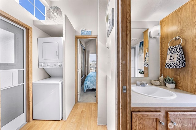 7704 Birch Bay Dr Unit 2805, Blaine, WA 98230 - ensuite bathroom with stacked washer / drying machine, wood finished floors, healthy amount of natural light, and vanity