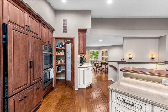 6753 Forest Ridge Dr, Wenatchee, WA 98801 - kitchen featuring stainless steel double oven, wood-type flooring, recessed lighting, light countertops, and a sink