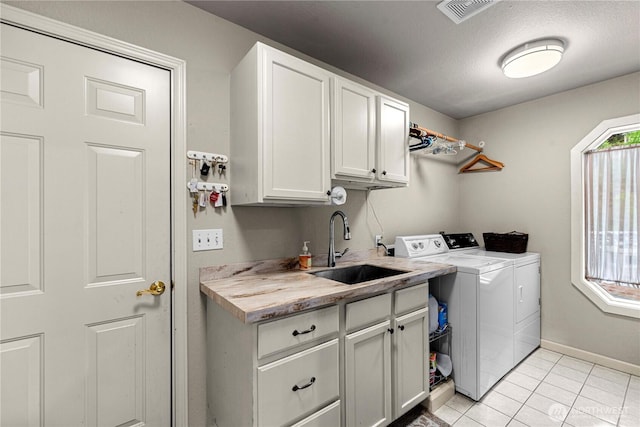 6753 Forest Ridge Dr, Wenatchee, WA 98801 - laundry room featuring separate washer and dryer, cabinet space, light tile patterned floors, and baseboards