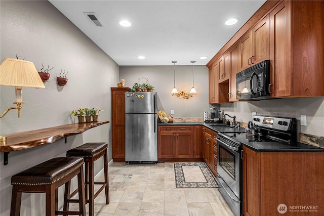 6753 Forest Ridge Dr, Wenatchee, WA 98801 - kitchen featuring stainless steel appliances, a sink, dark countertops, brown cabinetry, and hanging light fixtures