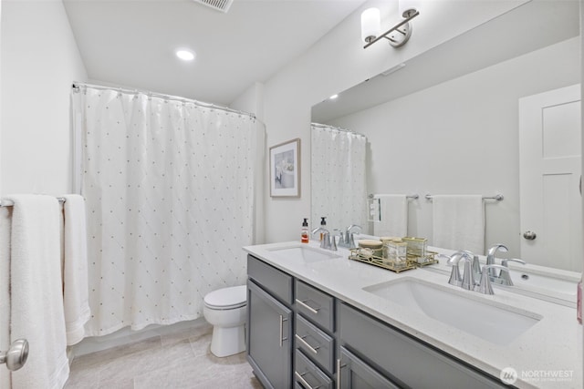 18230 134th Ave E, Puyallup, WA 98374 - full bathroom featuring toilet, double vanity, tile patterned floors, curtained shower, and recessed lighting