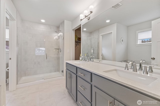 18230 134th Ave E, Puyallup, WA 98374 - full bathroom featuring double vanity, a stall shower, tile patterned flooring, a walk in closet, and recessed lighting