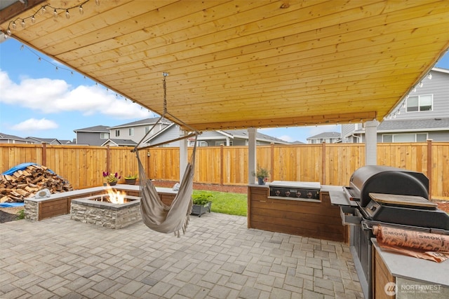 18230 134th Ave E, Puyallup, WA 98374 - fenced backyard with a fire pit, a patio, and a grill