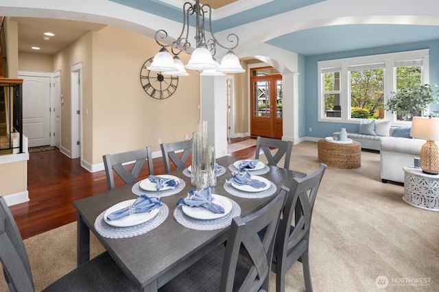 21515 26th St E, Lake Tapps, WA 98391 - carpeted dining room featuring arched walkways, baseboards, recessed lighting, and wood finished floors
