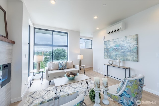 1019 Sturgus Ave S Unit A, Seattle, WA 98144 - living area featuring a wall mounted air conditioner, light wood-style flooring, recessed lighting, a fireplace, and baseboards