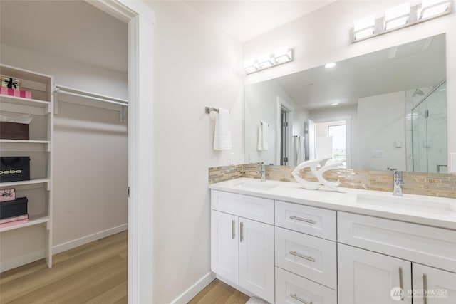1019 Sturgus Ave S Unit A, Seattle, WA 98144 - bathroom with tasteful backsplash, a stall shower, wood finished floors, a spacious closet, and baseboards