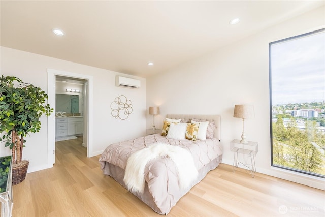 1019 Sturgus Ave S Unit A, Seattle, WA 98144 - bedroom with light wood-style floors, a wall unit AC, recessed lighting, baseboards, and ensuite bath