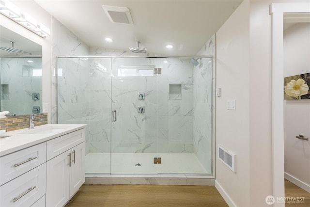 1019 Sturgus Ave S Unit A, Seattle, WA 98144 - bathroom featuring a marble finish shower, recessed lighting, vanity, and wood finished floors