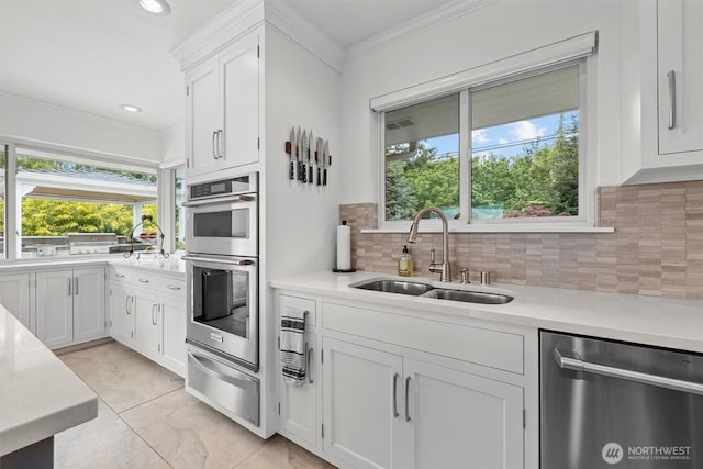 1505 E Horizon Dr, Mukilteo, WA 98275 - kitchen with appliances with stainless steel finishes, a sink, a warming drawer, light countertops, and crown molding