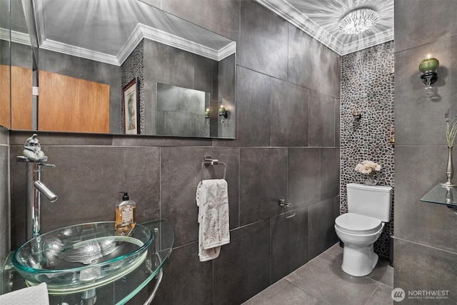1505 E Horizon Dr, Mukilteo, WA 98275 - bathroom featuring a sink, ornamental molding, toilet, tile walls, and tile patterned flooring