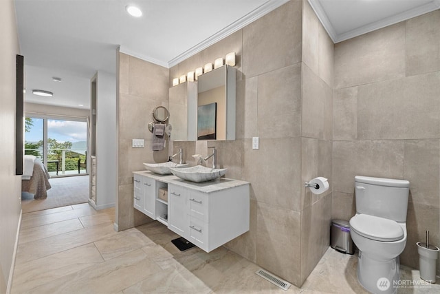 1505 E Horizon Dr, Mukilteo, WA 98275 - ensuite bathroom with crown molding, tile walls, toilet, vanity, and marble finish floors