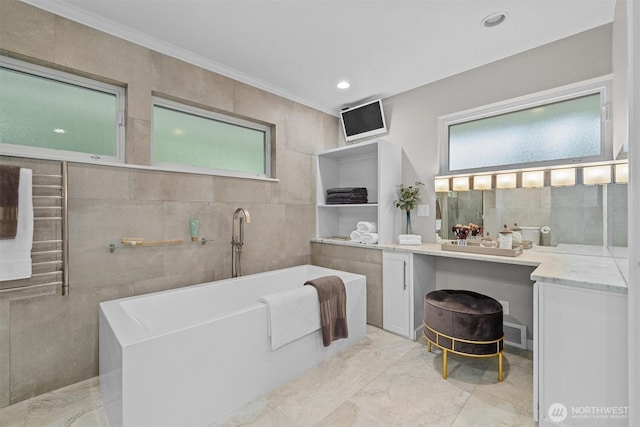 1505 E Horizon Dr, Mukilteo, WA 98275 - bathroom with marble tiled floors, a freestanding bath, tile walls, vanity, and ornamental molding