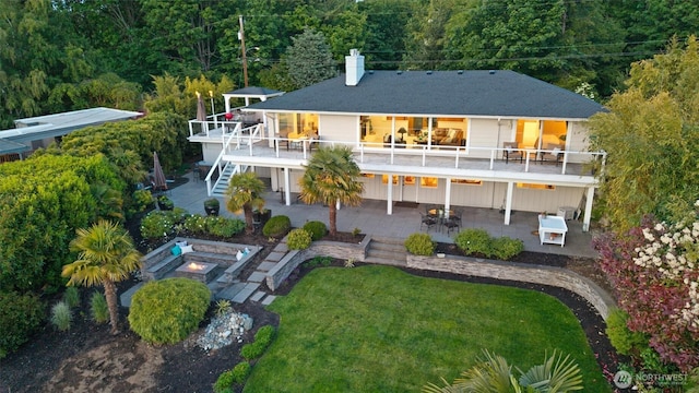 1505 E Horizon Dr, Mukilteo, WA 98275 - back of house featuring a patio, stairs, a chimney, a lawn, and a forest view