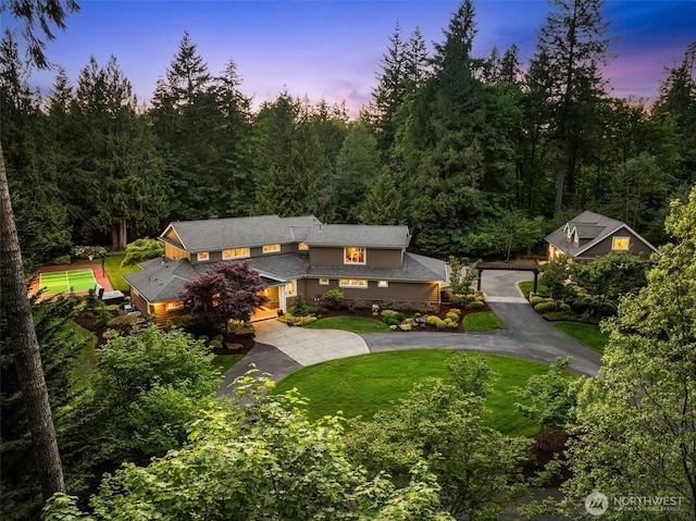 2920 39th Ln NW, Olympia, WA 98502 - view of front of home with curved driveway, a front lawn, and a view of trees