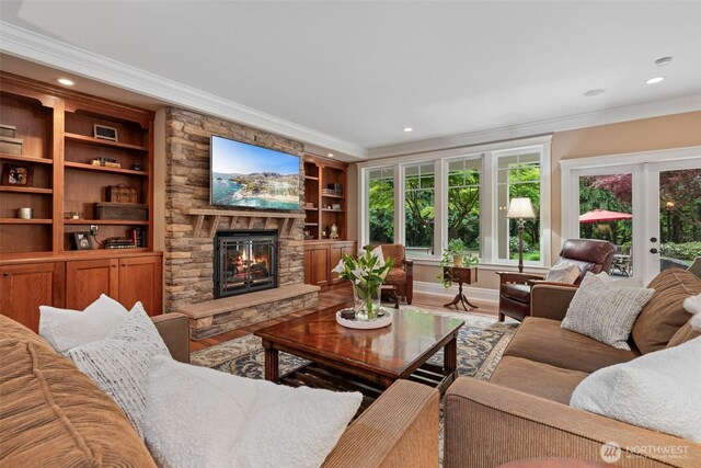 2920 39th Ln NW, Olympia, WA 98502 - living room with crown molding, a stone fireplace, recessed lighting, wood finished floors, and built in shelves