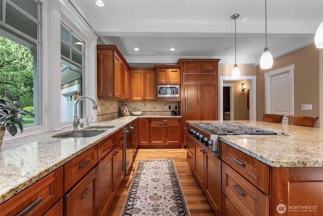 2920 39th Ln NW, Olympia, WA 98502 - kitchen featuring a sink, light wood-style floors, appliances with stainless steel finishes, brown cabinets, and recessed lighting