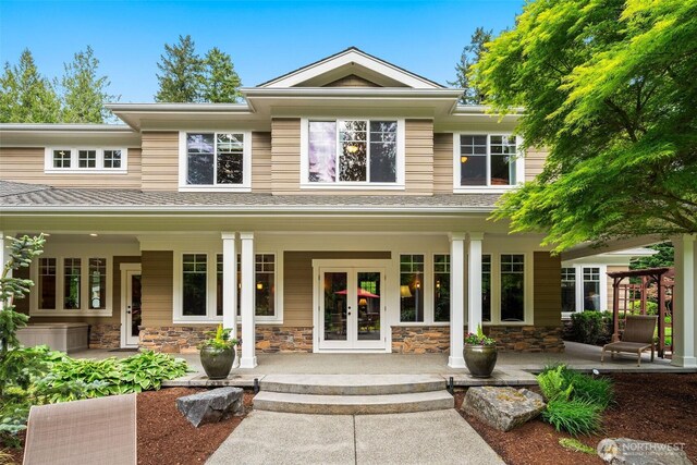 2920 39th Ln NW, Olympia, WA 98502 - view of front of home featuring french doors, covered porch, and stone siding