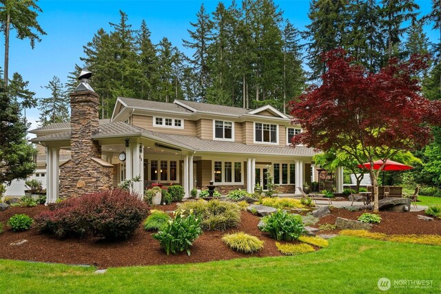 2920 39th Ln NW, Olympia, WA 98502 - view of front of home with french doors, a front yard, stone siding, a patio, and a chimney