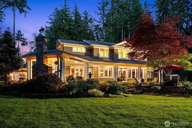 2920 39th Ln NW, Olympia, WA 98502 - back of house at dusk featuring a lawn and a chimney