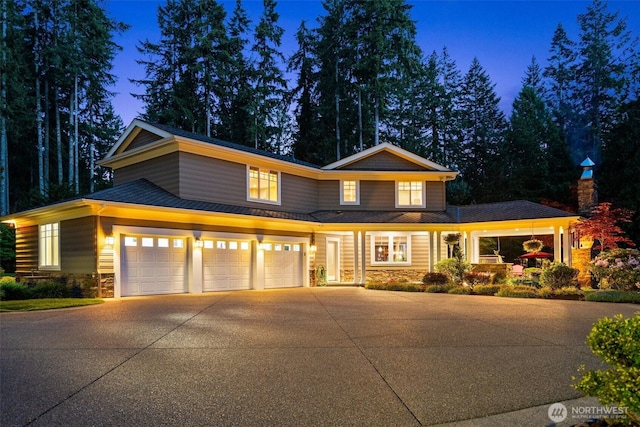 2920 39th Ln NW, Olympia, WA 98502 - view of front of house with stone siding, concrete driveway, and an attached garage