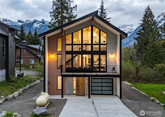 400 Hyak Dr E, Snoqualmie Pass, WA 98068 - view of front facade with a mountain view, driveway, an attached garage, and a balcony