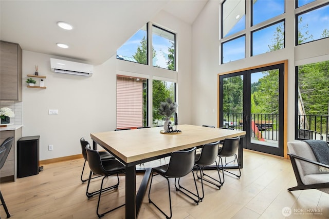 400 Hyak Dr E, Snoqualmie Pass, WA 98068 - dining room with a wall mounted air conditioner, light wood-type flooring, recessed lighting, a towering ceiling, and baseboards