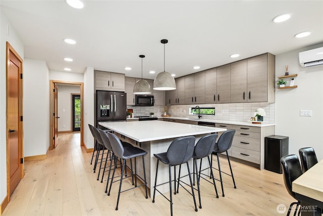 400 Hyak Dr E, Snoqualmie Pass, WA 98068 - kitchen featuring fridge with ice dispenser, black microwave, an AC wall unit, a breakfast bar area, and backsplash