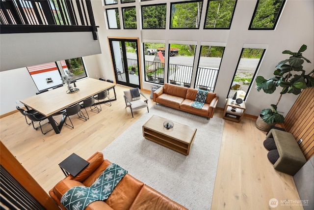 400 Hyak Dr E, Snoqualmie Pass, WA 98068 - living room with wood finished floors, a high ceiling, and baseboards