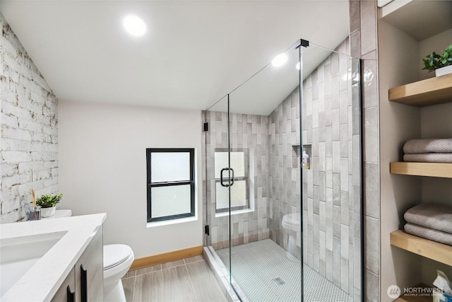 400 Hyak Dr E, Snoqualmie Pass, WA 98068 - bathroom with lofted ceiling, toilet, vanity, a shower stall, and baseboards