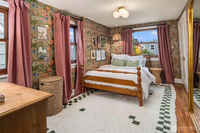 4332 NE 43rd St, Seattle, WA 98105 - bedroom featuring wallpapered walls, wood finished floors, and baseboards