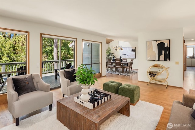 6160 W Mercer Way, Mercer Island, WA 98040 - living area featuring healthy amount of natural light, light wood-style flooring, and a chandelier
