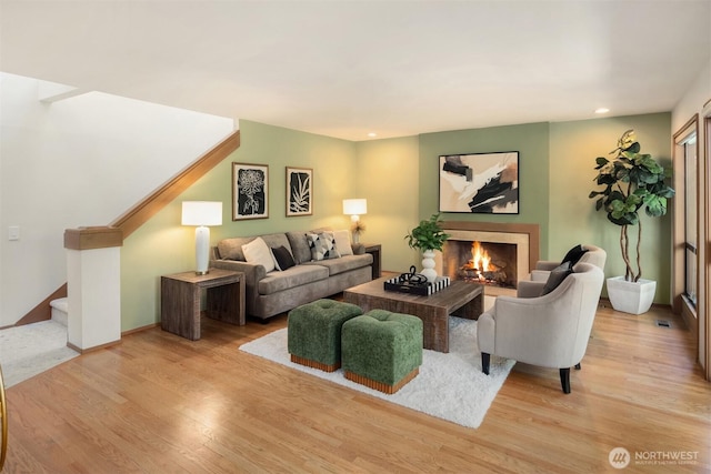 6160 W Mercer Way, Mercer Island, WA 98040 - living area featuring stairway, wood finished floors, a warm lit fireplace, recessed lighting, and baseboards