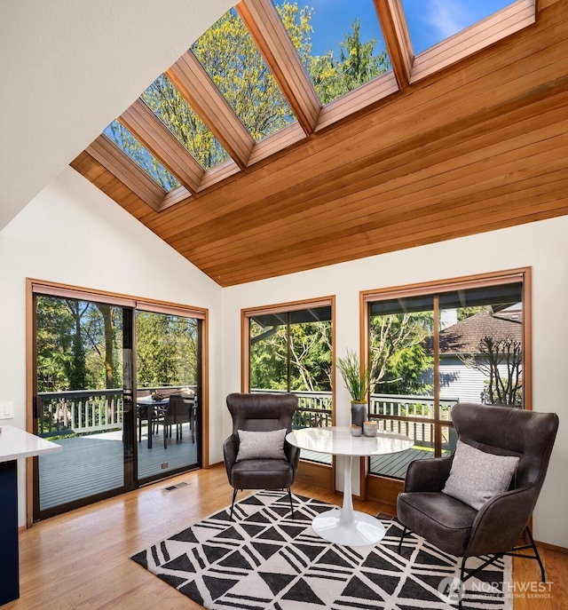 6160 W Mercer Way, Mercer Island, WA 98040 - sitting room featuring a skylight, plenty of natural light, high vaulted ceiling, and light wood-style floors