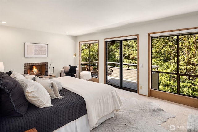 6160 W Mercer Way, Mercer Island, WA 98040 - bedroom featuring access to exterior, light carpet, a fireplace, and recessed lighting
