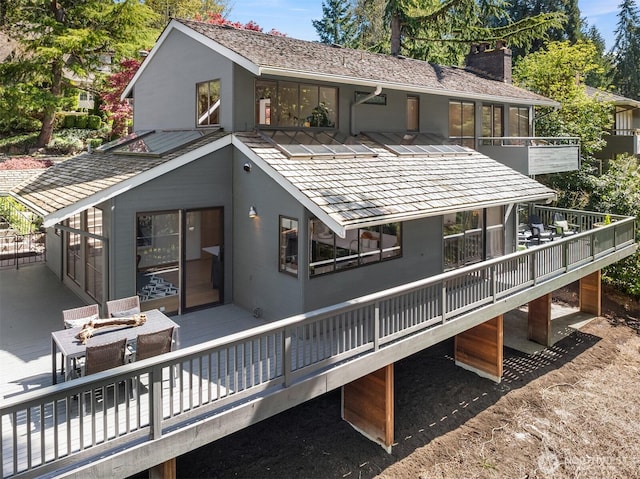 6160 W Mercer Way, Mercer Island, WA 98040 - back of property with a chimney, a wooden deck, and stucco siding
