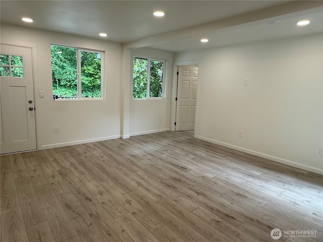 empty room featuring wood finished floors, baseboards, and recessed lighting
