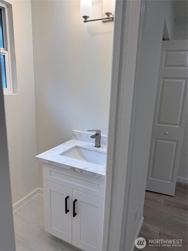 bathroom with vanity and baseboards